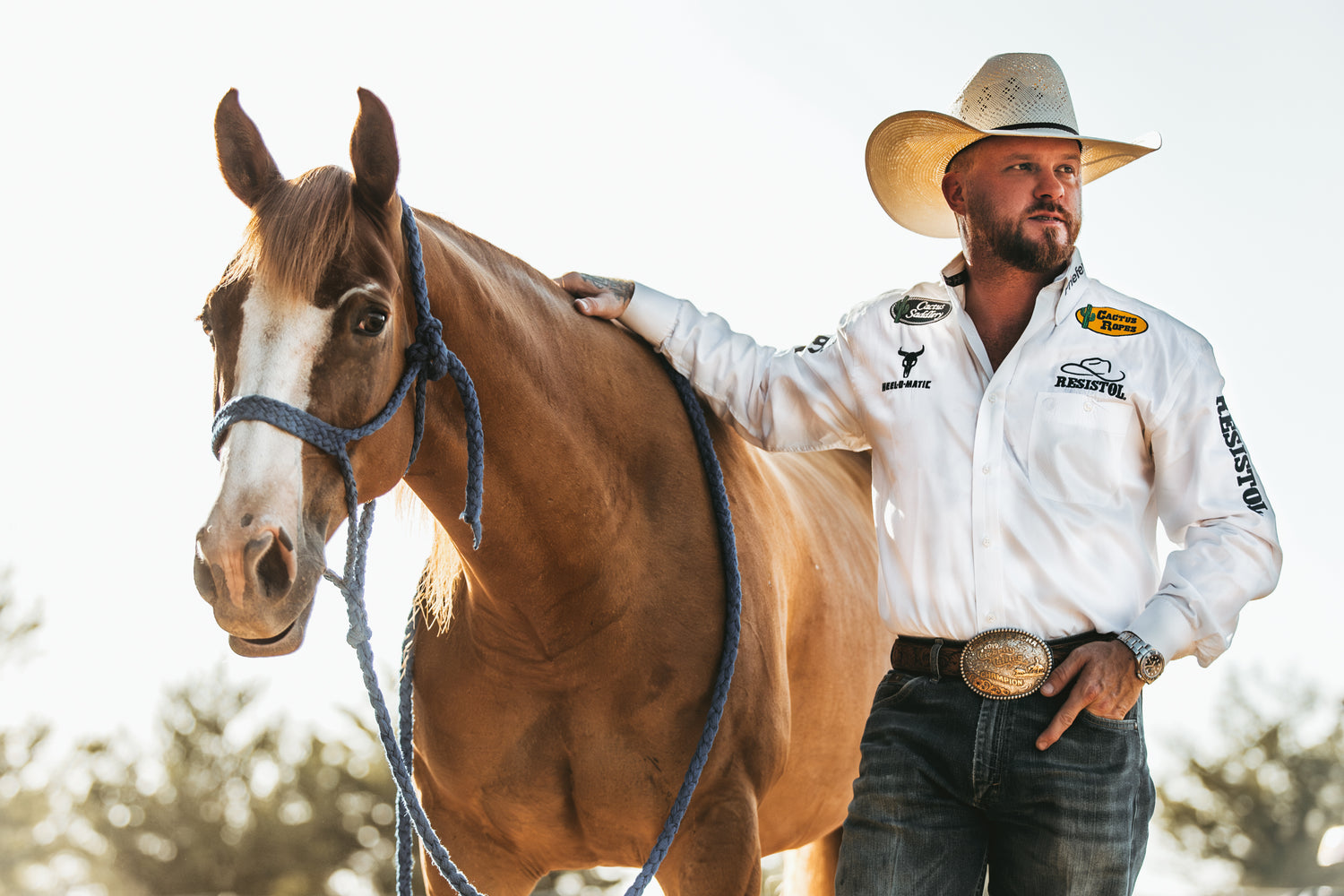 Wranglers standing near horse
